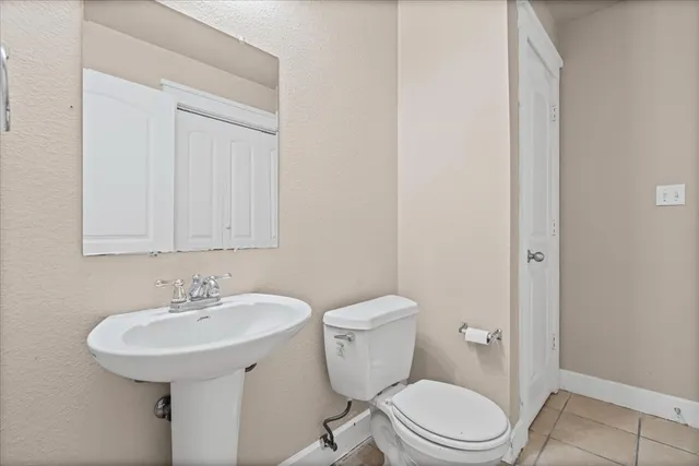 a bathroom with a toilet a sink and a mirror