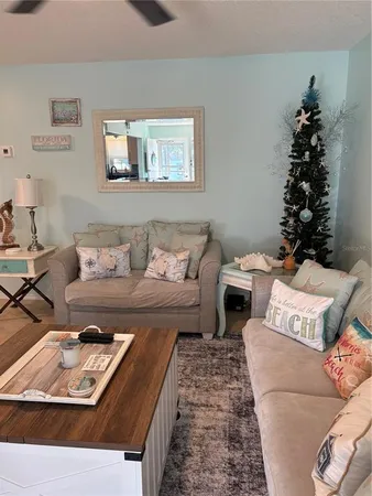 a living room with furniture and flowers