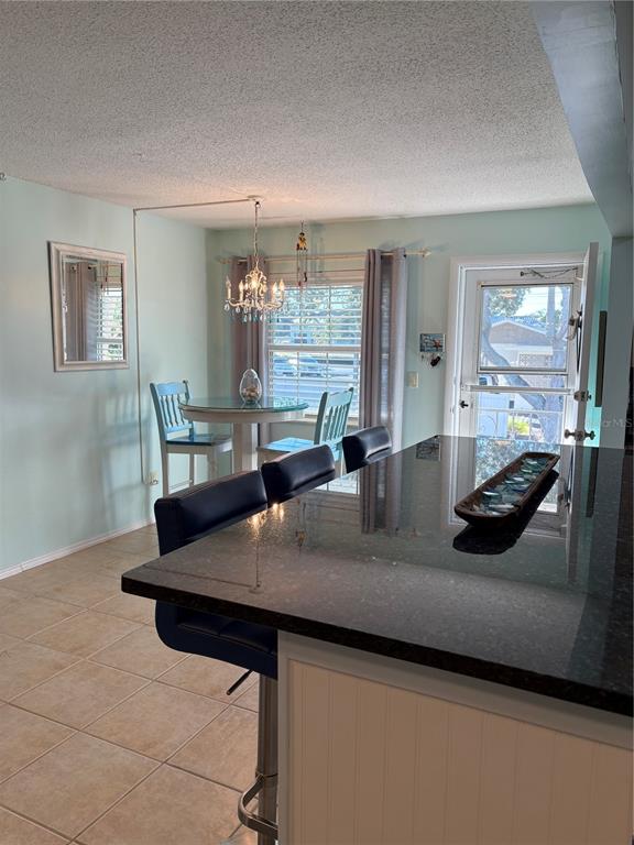 14531 Walsingham Road, Unit 224 Largo, FL 33774 - Photo 12 of 41 a view of kitchen island a sink wooden floor dining table and chairs