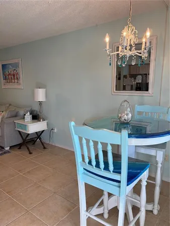 a view of a dining room with furniture and chandelier