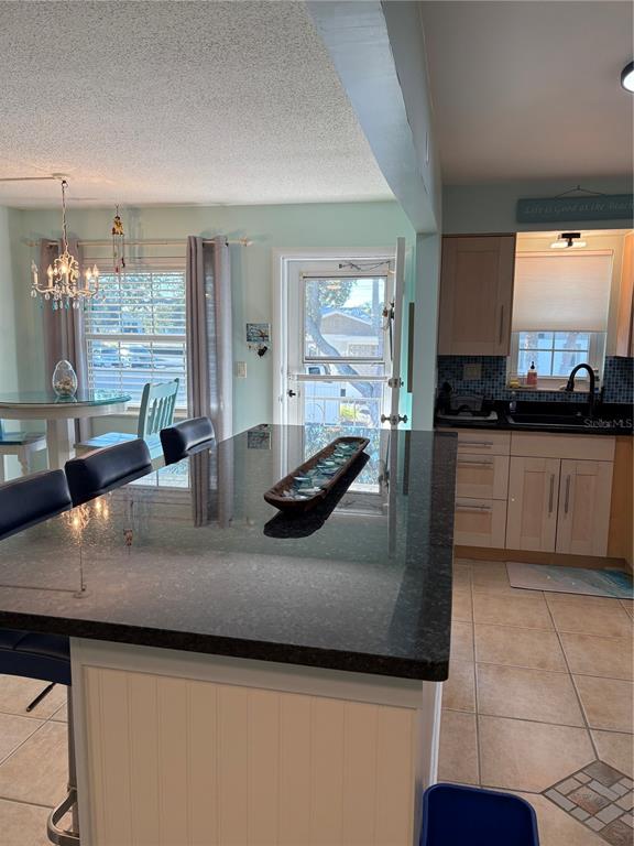 14531 Walsingham Road, Unit 224 Largo, FL 33774 - Photo 16 of 41 a kitchen with granite countertop a sink and a stove