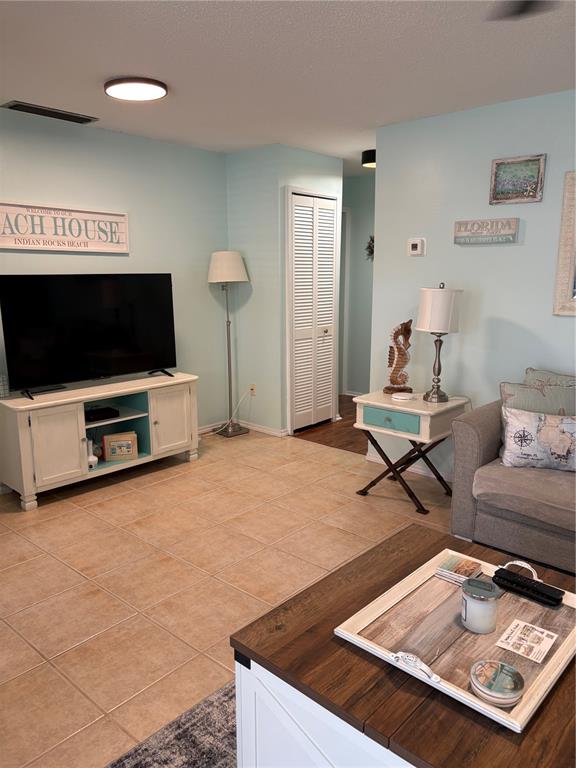 14531 Walsingham Road, Unit 224 Largo, FL 33774 - Photo 17 of 41 a living room with furniture and a flat screen tv