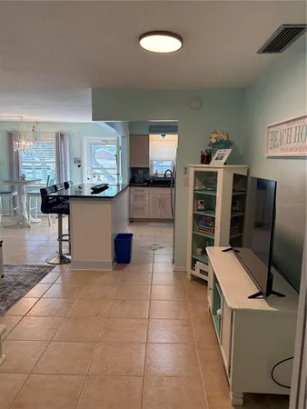 a kitchen with stainless steel appliances kitchen island granite countertop a refrigerator and a stove
