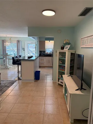 a kitchen with stainless steel appliances kitchen island granite countertop a refrigerator and a stove