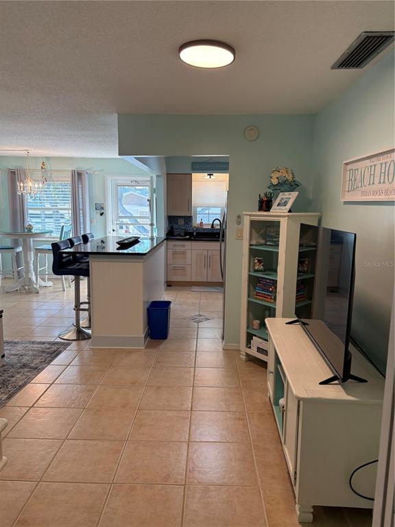 14531 Walsingham Road, Unit 224 Largo, FL 33774 - Photo 20 of 41 a kitchen with stainless steel appliances kitchen island granite countertop a refrigerator and a stove
