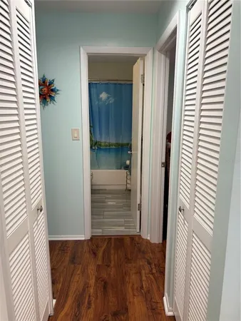 a view of entryway with wooden floor and cabinet