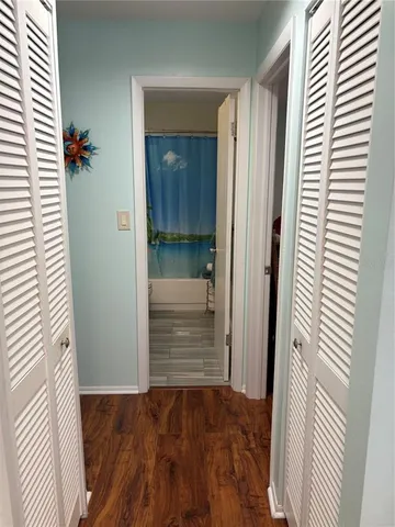 a view of entryway with wooden floor and cabinet