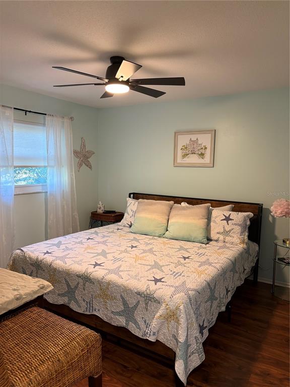 14531 Walsingham Road, Unit 224 Largo, FL 33774 - Photo 23 of 41 a bedroom with bed and wooden floor