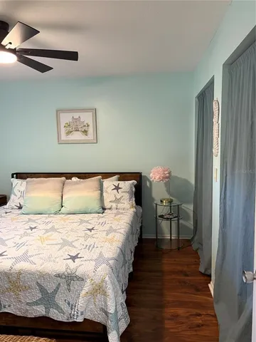 a bed sitting in a bedroom next to a window with a chandelier