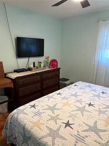 a bedroom with a bed and a flat screen tv