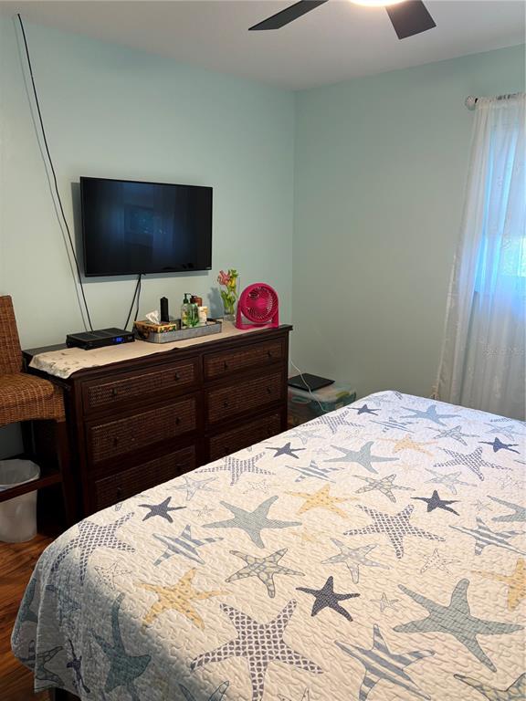 14531 Walsingham Road, Unit 224 Largo, FL 33774 - Photo 26 of 41 a bedroom with a bed and a flat screen tv