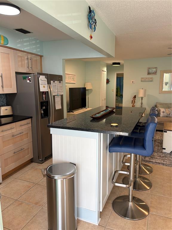14531 Walsingham Road, Unit 224 Largo, FL 33774 - Photo 3 of 41 a kitchen with a refrigerator and a stove top oven