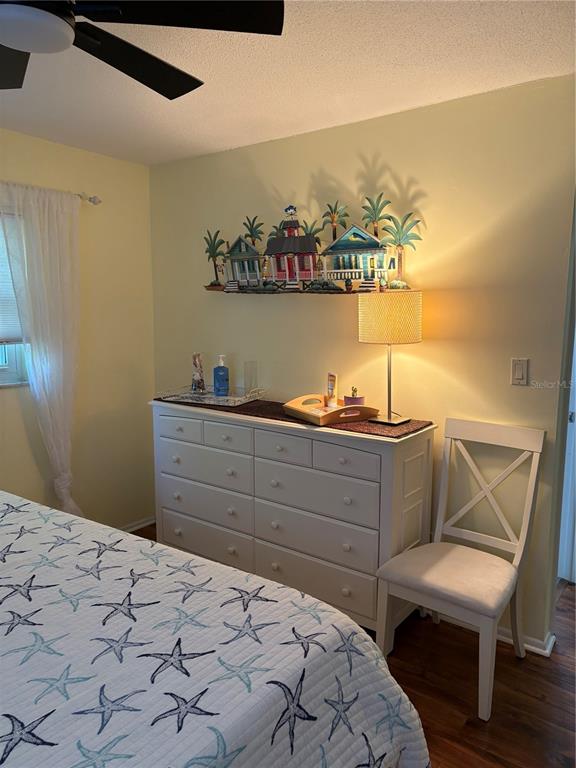 14531 Walsingham Road, Unit 224 Largo, FL 33774 - Photo 36 of 41 a bedroom with a bed and a table in it