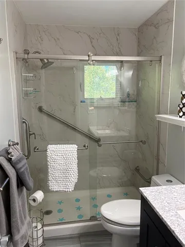 a bathroom with a sink mirror and vanity