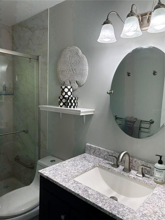 14531 Walsingham Road, Unit 224 Largo, FL 33774 - Photo 41 of 41 a bathroom with a sink mirror and vanity