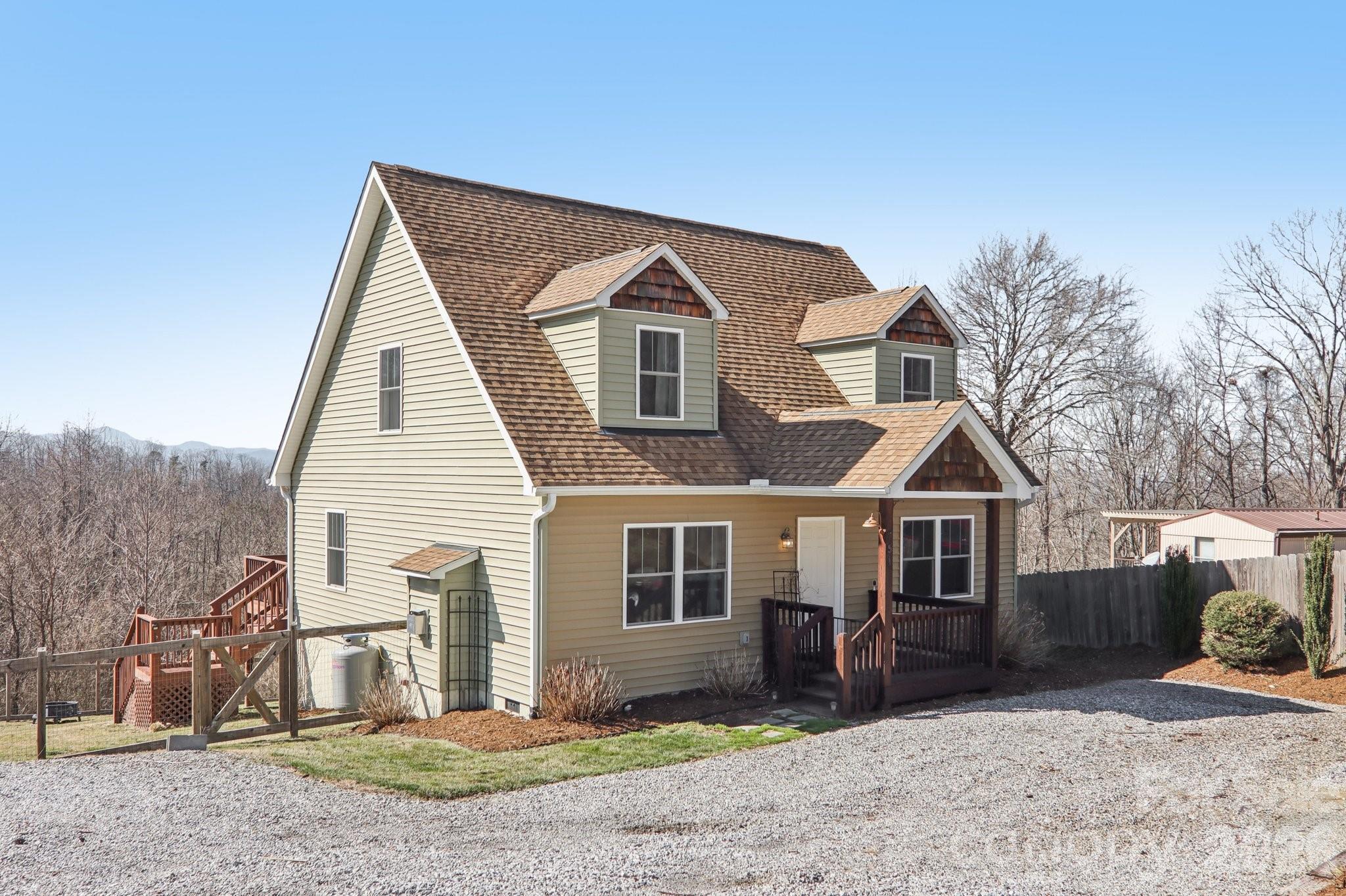 751 Hutch Mountain Road Fletcher, NC 28732 - Photo 3 of 48 a front view of a house with a yard