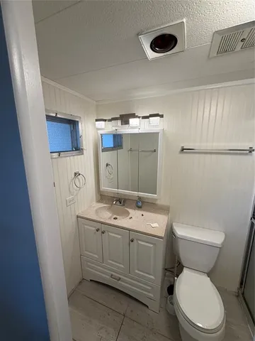 a view of a patio with table and chairs potted plants with the floor to ceiling window
