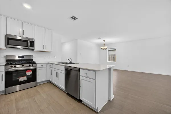 a kitchen with granite countertop a stove and a sink