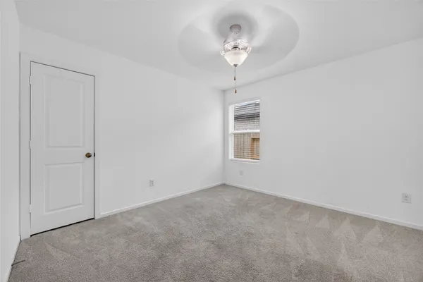 a view of empty room with a chandelier fan