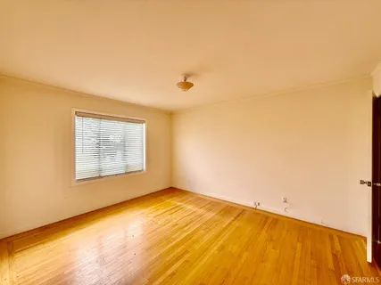 a view of empty room with wooden walls