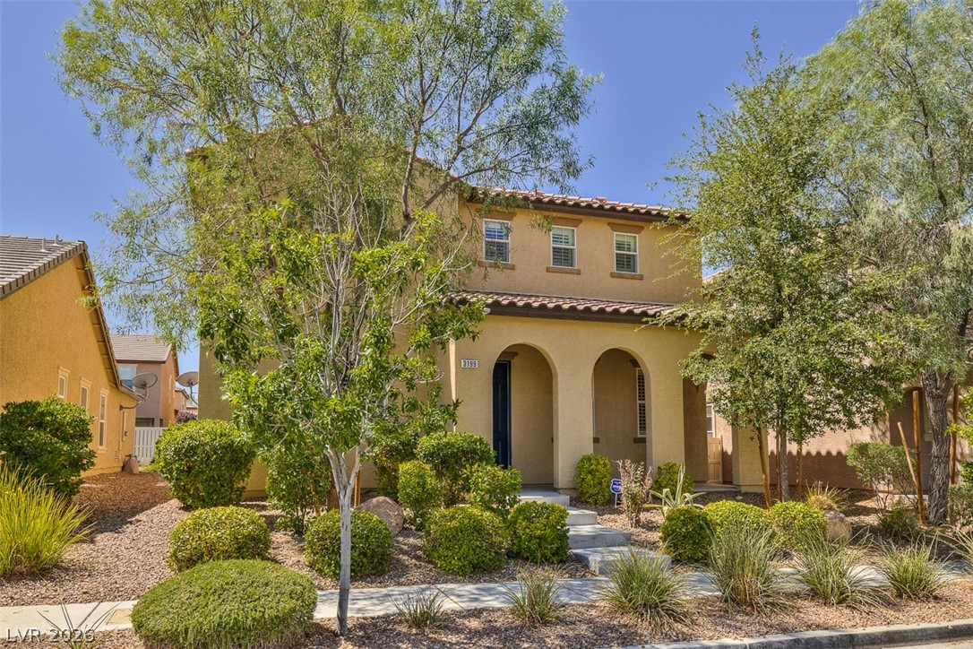 3199 Subtle Color Avenue Henderson, NV 89044 - Photo 2 of 46 Mediterranean / spanish-style house featuring a porch, a tiled roof, and stucco siding