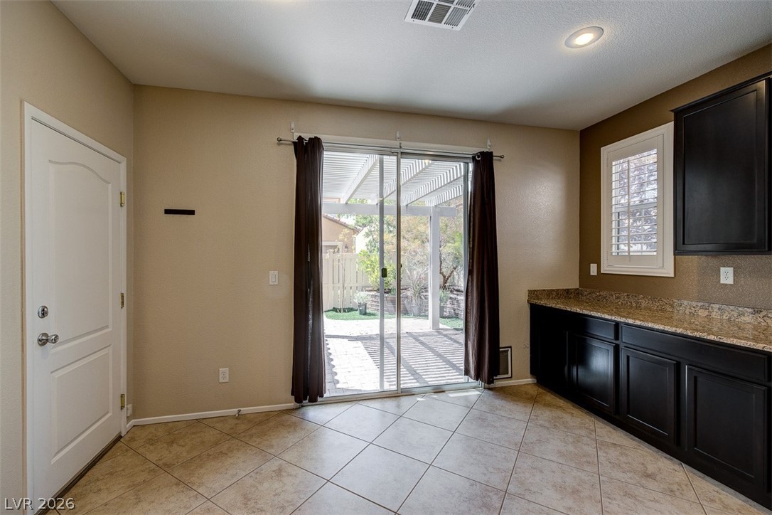 3199 Subtle Color Avenue Henderson, NV 89044 - Photo 19 of 46 Doorway with tile patterned flooring and baseboards