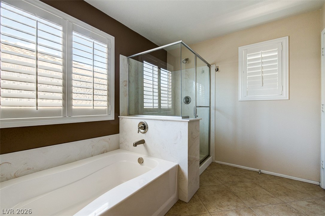3199 Subtle Color Avenue Henderson, NV 89044 - Photo 27 of 46 Bathroom with a shower stall, a bath, and light tile patterned flooring