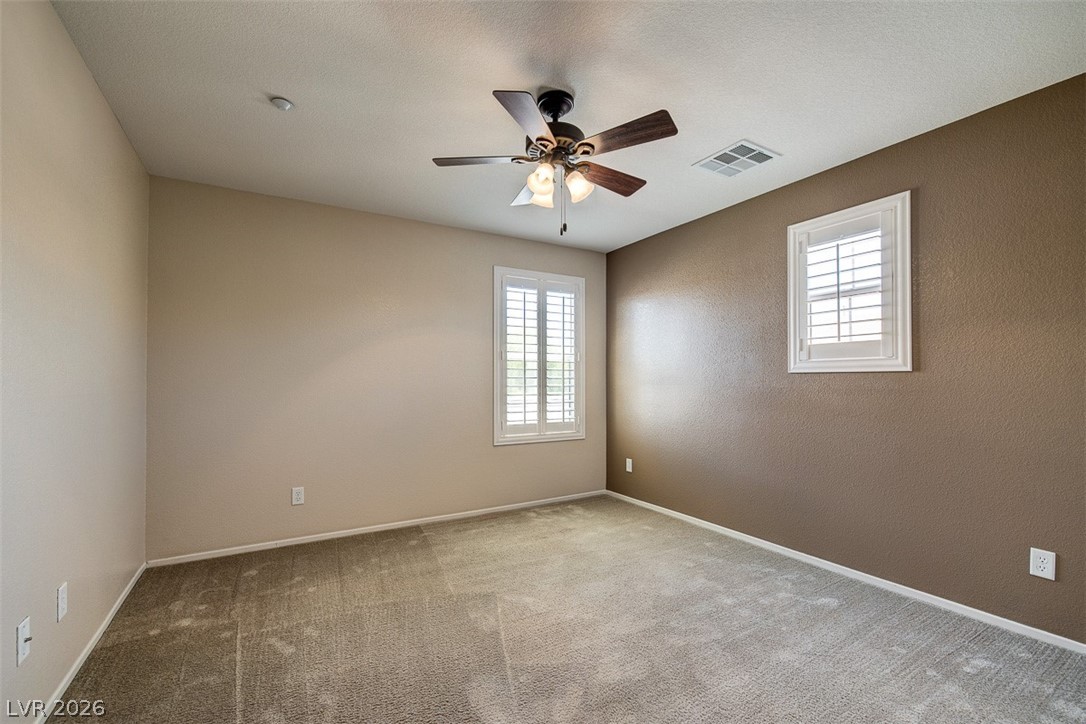 3199 Subtle Color Avenue Henderson, NV 89044 - Photo 33 of 46 Carpeted empty room featuring ceiling fan and baseboards