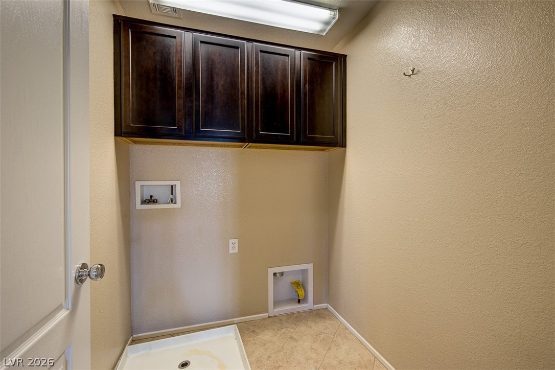 3199 Subtle Color Avenue Henderson, NV 89044 - Photo 35 of 46 Laundry area featuring a textured wall, hookup for a washing machine, and cabinet space
