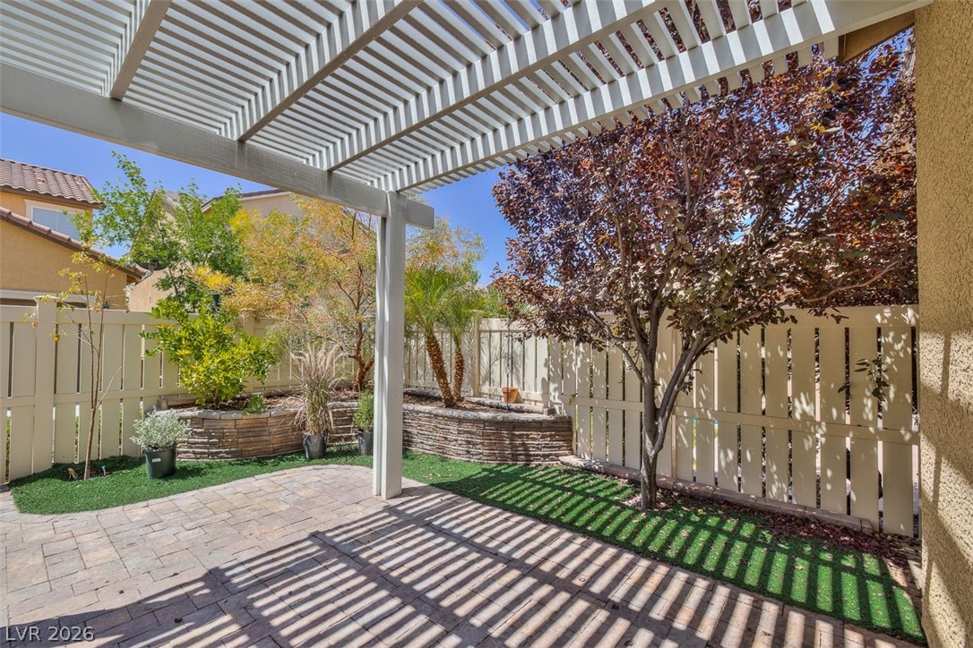 3199 Subtle Color Avenue Henderson, NV 89044 - Photo 37 of 46 Fenced backyard with a patio area and a pergola