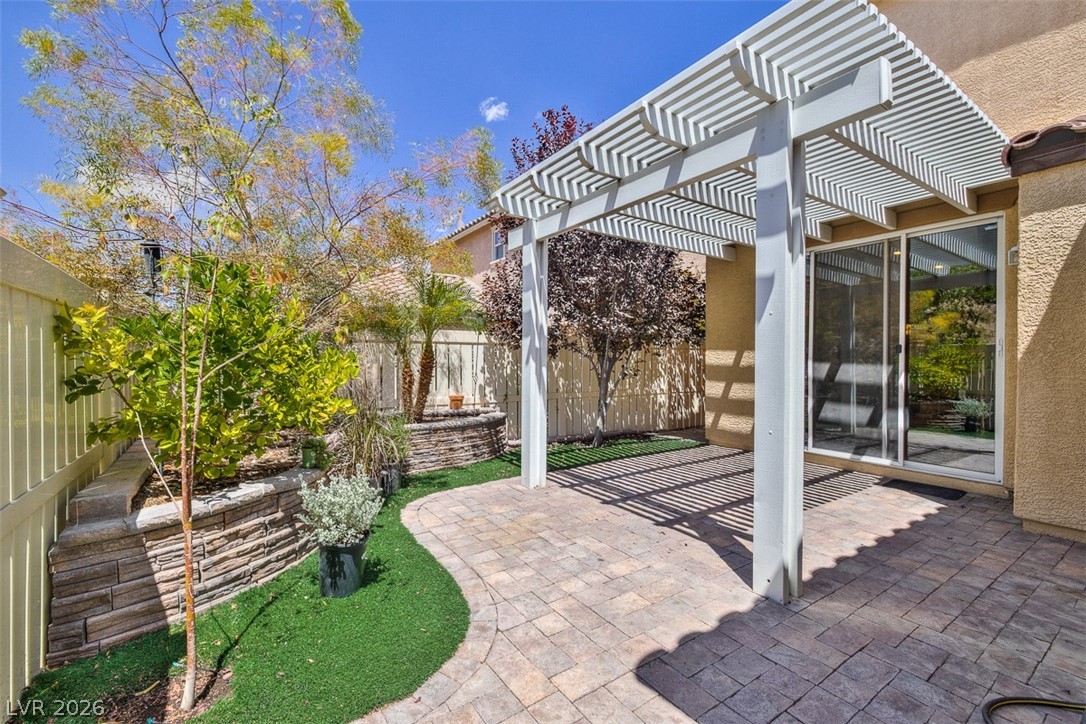 3199 Subtle Color Avenue Henderson, NV 89044 - Photo 40 of 46 Fenced backyard with a patio and a pergola