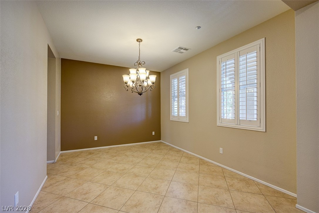 3199 Subtle Color Avenue Henderson, NV 89044 - Photo 6 of 46 Unfurnished room featuring suspended lighting and light tile patterned floors