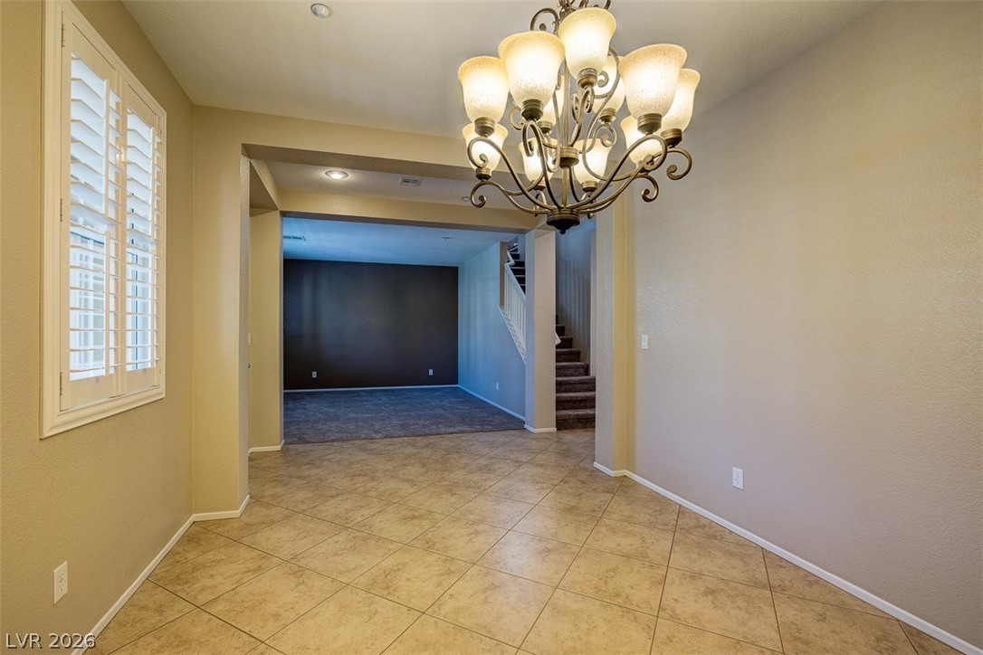 3199 Subtle Color Avenue Henderson, NV 89044 - Photo 9 of 46 Unfurnished dining area featuring suspended lighting and light tile patterned floors