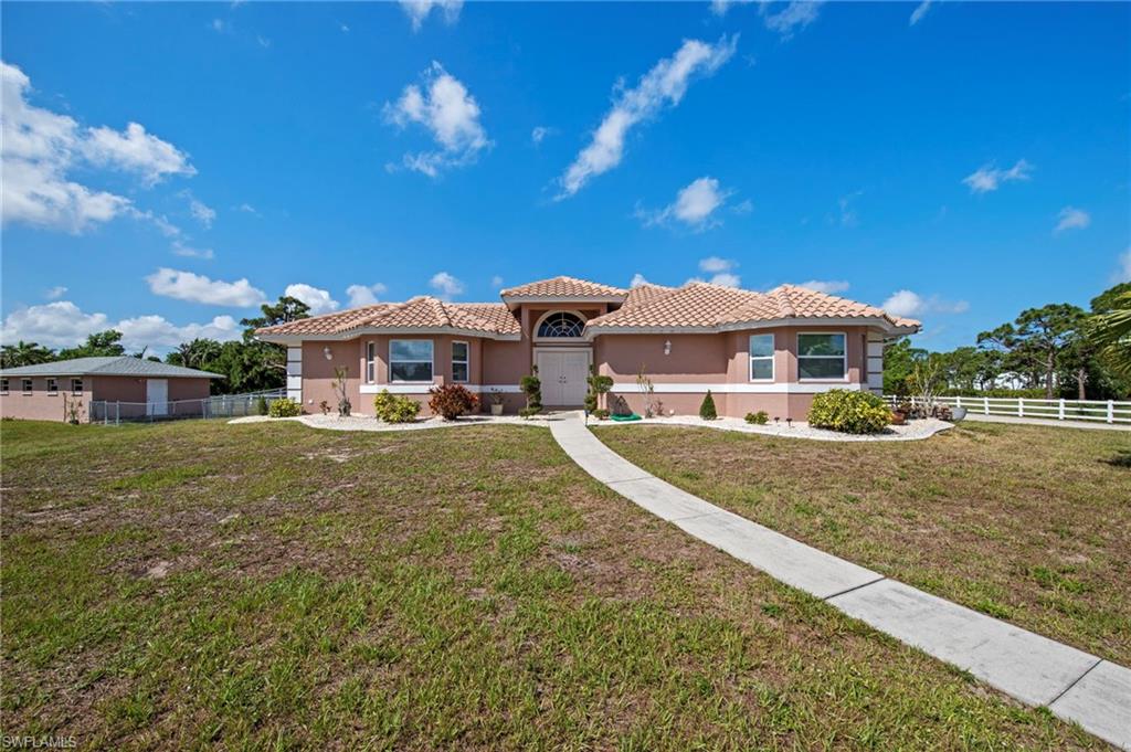 13541 Stringfellow Road Bokeelia, FL 33922 - Photo 3 of 49 a front view of a house with a yard