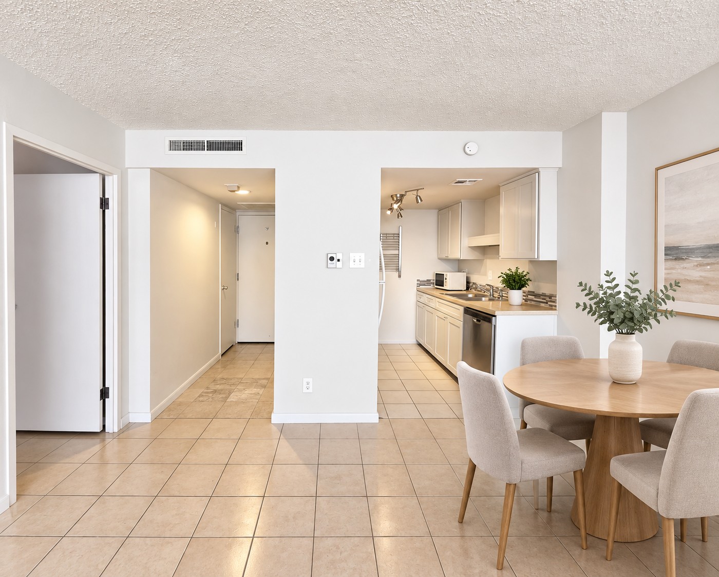 1800 Lavaca Street, Unit 107 Austin, TX 78701 - Photo 7 of 16 Continuous tile flooring connects the welcoming dining space and streamlined kitchen layout.