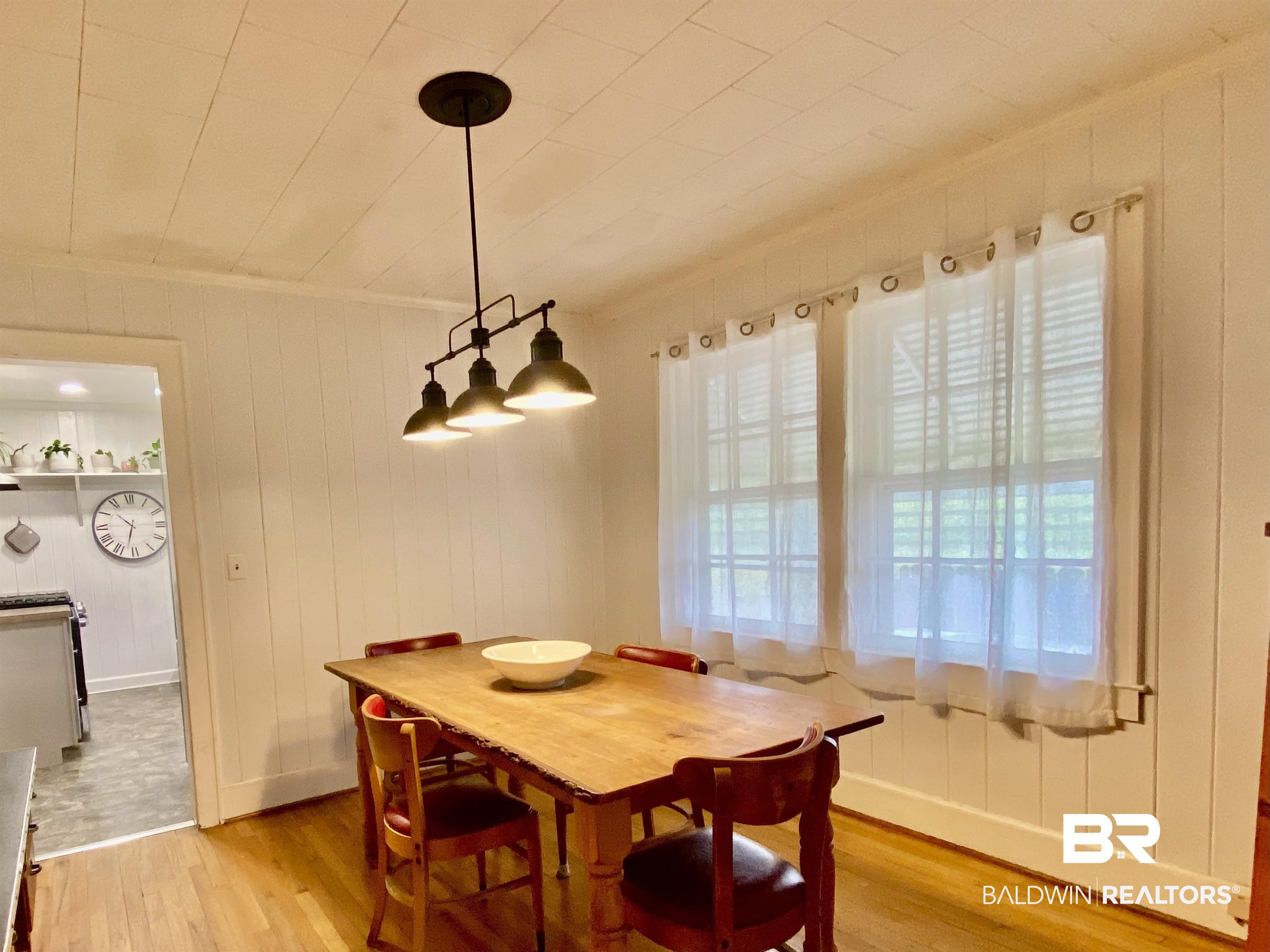 770 Arena Road Frisco City, AL 36445 - Photo 15 of 51 Dining space featuring a wealth of natural light, baseboards, light wood finished floors, and ornamental molding