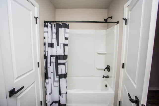 a bathroom with a shower and a tub