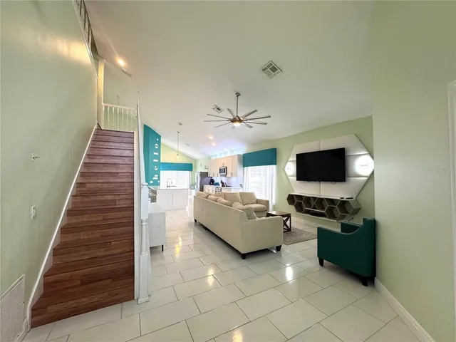 a living room with furniture and a flat screen tv