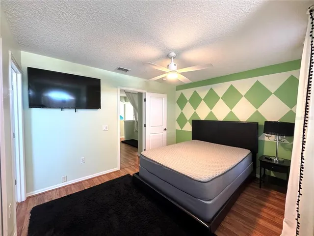 a room with a bed and a flat screen tv