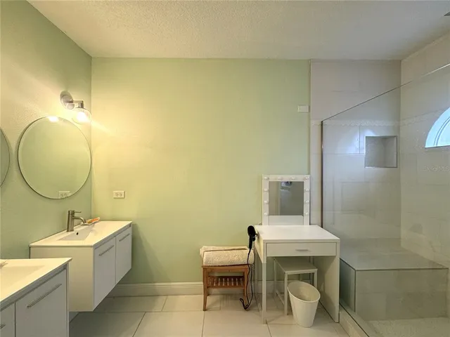 a bathroom with a sink mirror and toilet