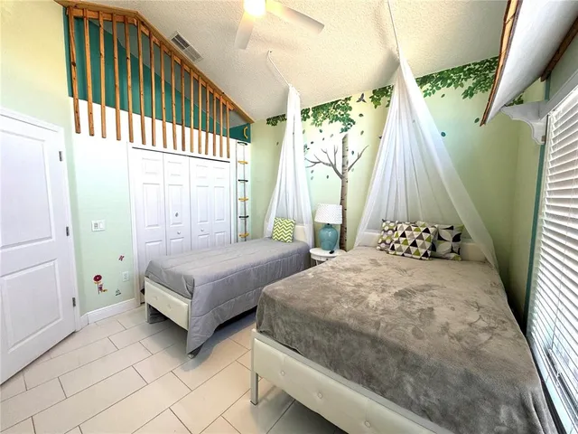 a bedroom with two beds and a baby crib