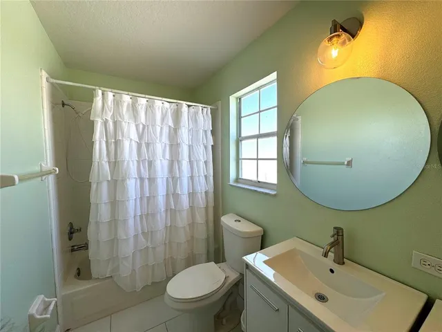 a bathroom with a sink mirror and toilet