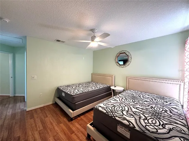 a bedroom with two beds and a chandelier