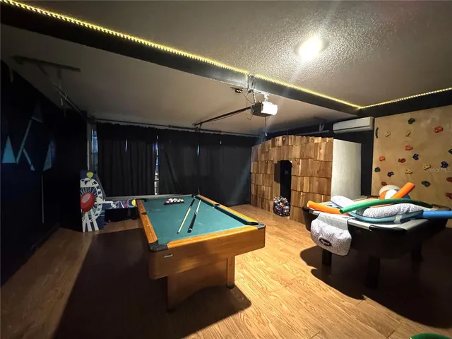 a living room with furniture and a pool table
