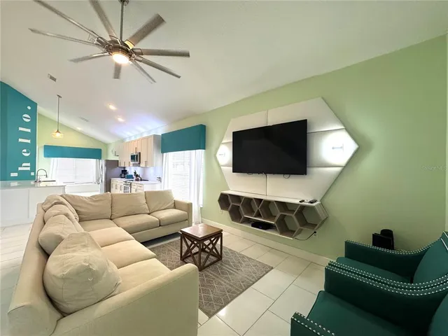 a living room with furniture and a flat screen tv