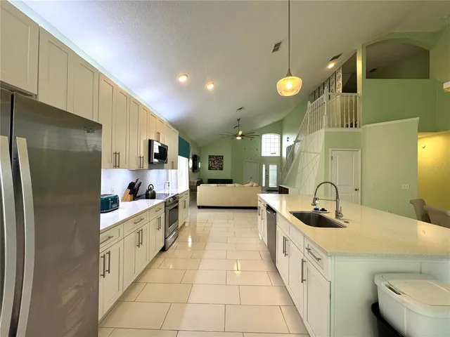 a kitchen with stainless steel appliances granite countertop a sink and cabinets