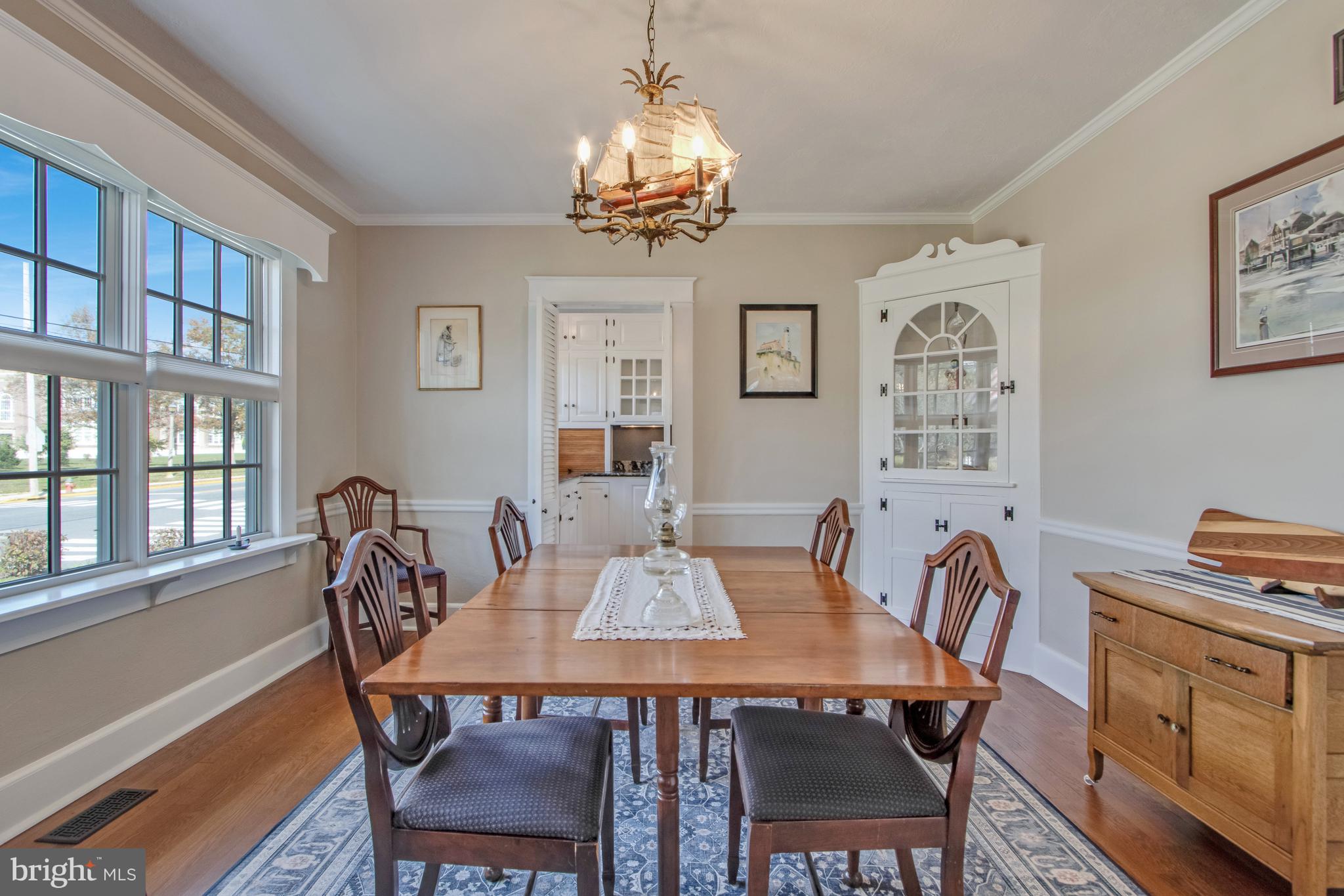 901 Savannah Road Lewes, DE 19958 - Photo 12 of 83 a view of a dining room with furniture a chandelier and a window