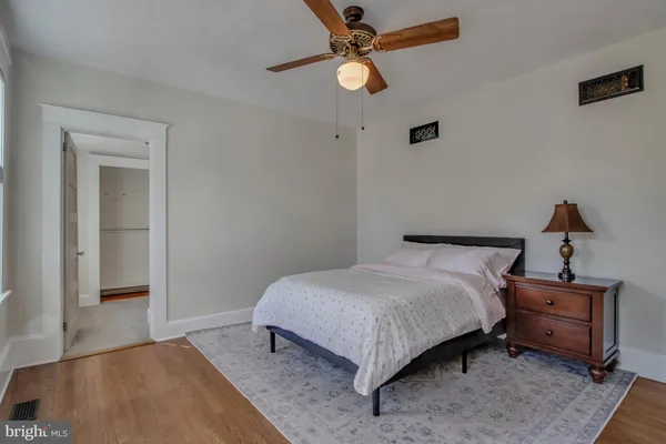 a bathroom with a granite countertop sink a mirror and a shower