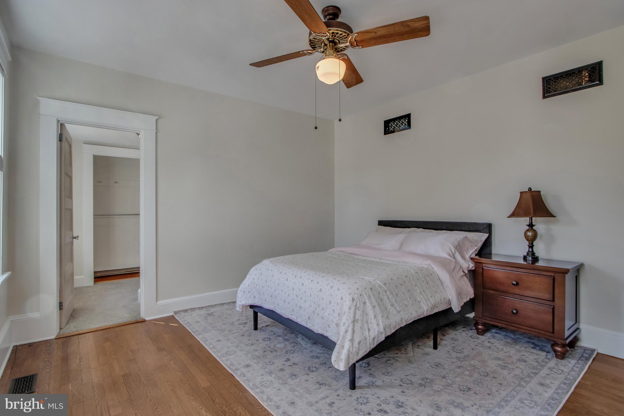 901 Savannah Road Lewes, DE 19958 - Photo 16 of 83 a bedroom with a bed and a chandelier