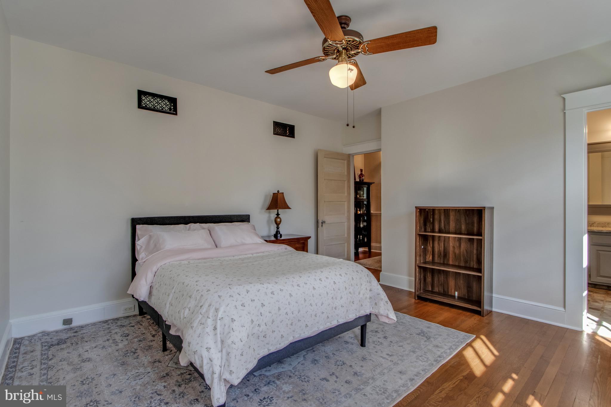 901 Savannah Road Lewes, DE 19958 - Photo 17 of 83 a bedroom with a bed and a chandelier